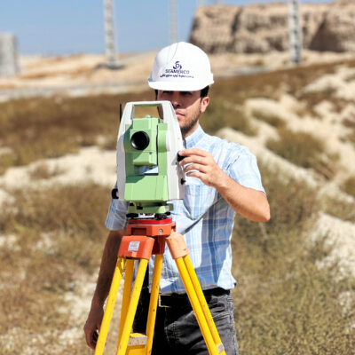 Seamerco surveyor using a total station at a factory site
